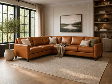 A large, L-shaped corner sectional in a warm cognac leather finish. 