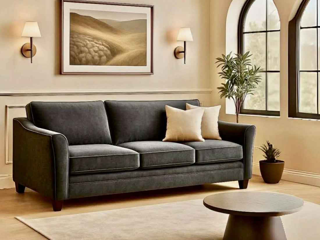 Custom Tyson sofa with two pillows against a light wall with a painting.