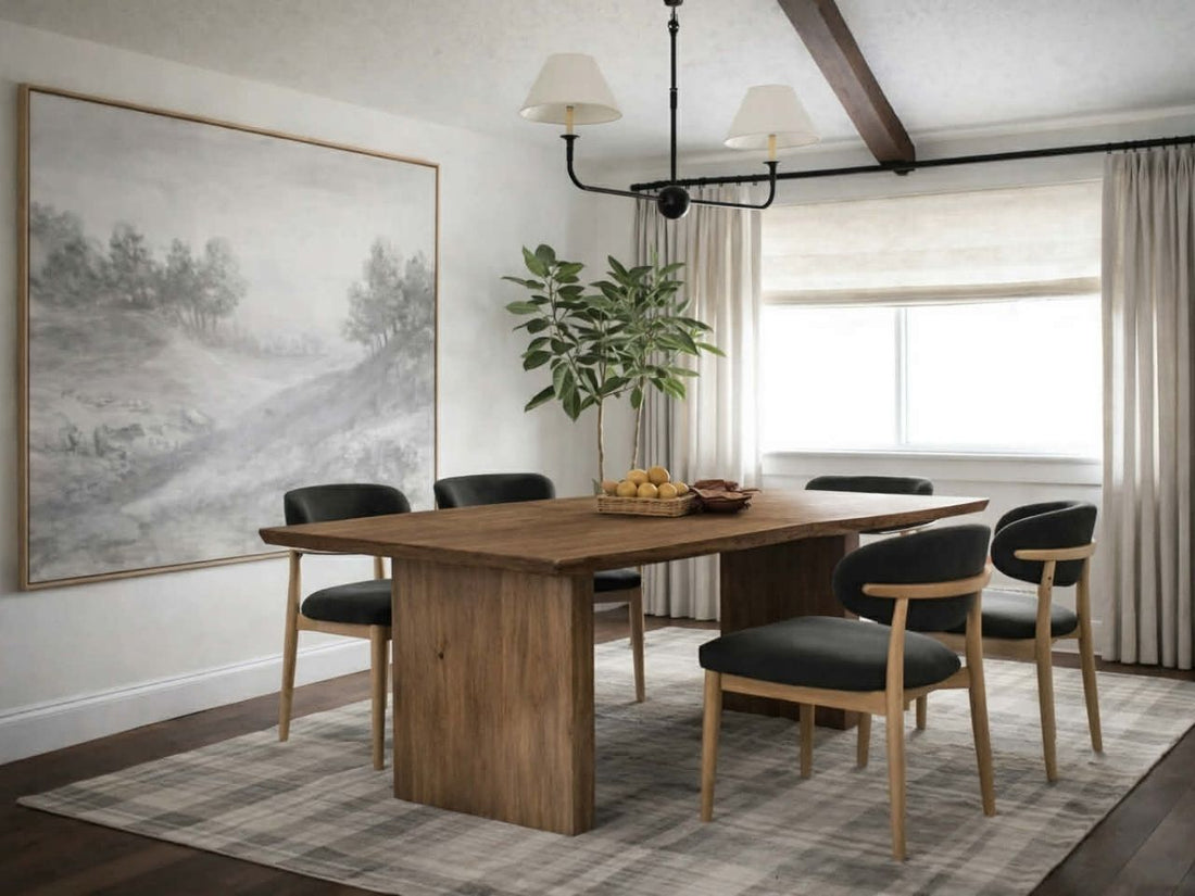 Rectangular wooden dining table with pedestal legs and six upholstered chairs in a bright, modern dining room.