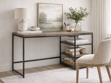 The Dandhi Multi-level Desk features a minimalist industrial design. It is constructed with a thick, rectangular tabletop made of textured wood with a weathered, multi-tonal brown finish.