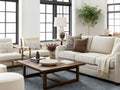 Modern living room with beige Denver sofa, armchairs, and a wooden coffee table by Showhome Furniture