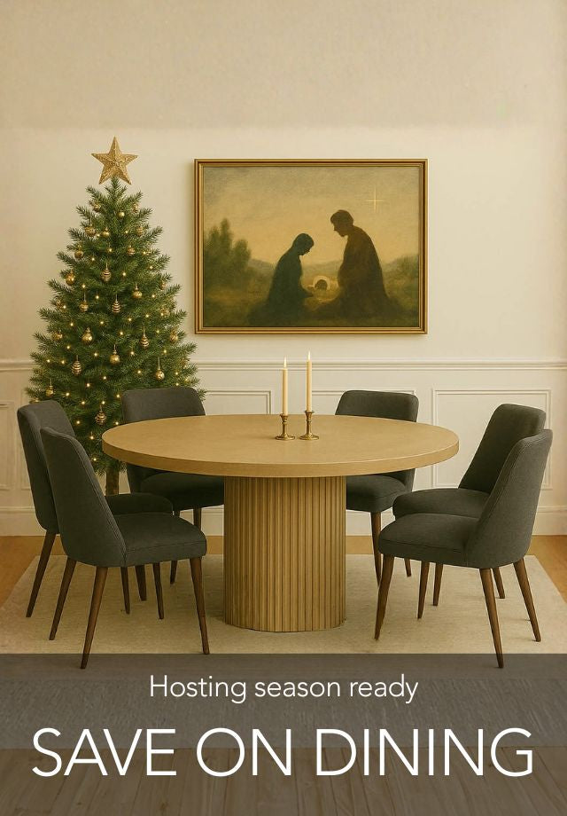 Dining room with round table in Calgary and chairs, Christmas tree, and framed artwork by Showhome Furniture in Calgary