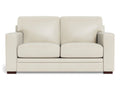 A two-seat leather loveseat with a minimalist, contemporary shape, wide arms, and smooth cushions, shown in a soft off-white leather finish on a white background.