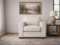 Cream accent chair upholstered in smooth leather or leather-look material, styled in a bright, neutral living room.