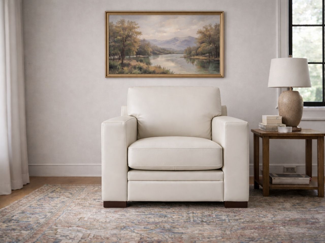 Cream accent chair upholstered in smooth leather or leather-look material, styled in a bright, neutral living room.