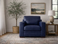 Blue leather armchair with padded cushions, styled in a neutral living room setting.