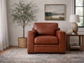 Nutmeg leather accent chair with plush seating, placed in a cozy, classic living room.