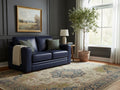 Navy blue loveseat upholstered in leather or leather-like material, set against dark paneled walls with classic décor.