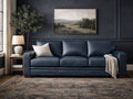 Navy blue leather three-seat sofa with clean lines, set against dark paneled walls with classic décor.