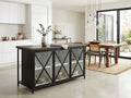 Black kitchen island with glass cabinet doors in a modern dining space.