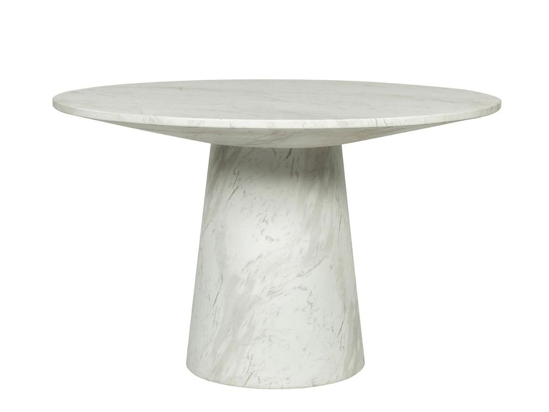 Round marble dining table with upholstered chairs in a bright, elegant dining room.