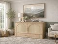 Light wood cabinet bed styled as a sideboard in a bright living room with neutral décor.