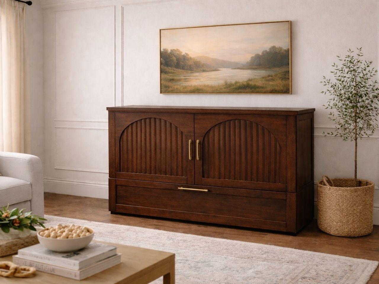 Dark wood cabinet bed with arched paneled doors and brass handles, styled in a warm, classic living room.