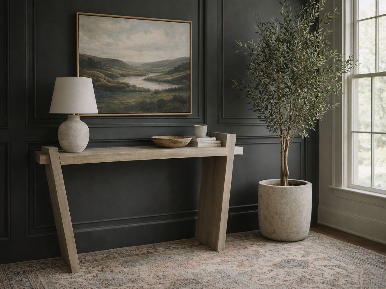 A modern light-wood console table with a thick rectangular top and two wide, angled slab legs. 