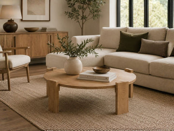 Round wood coffee table with a low-profile design in a modern living room.