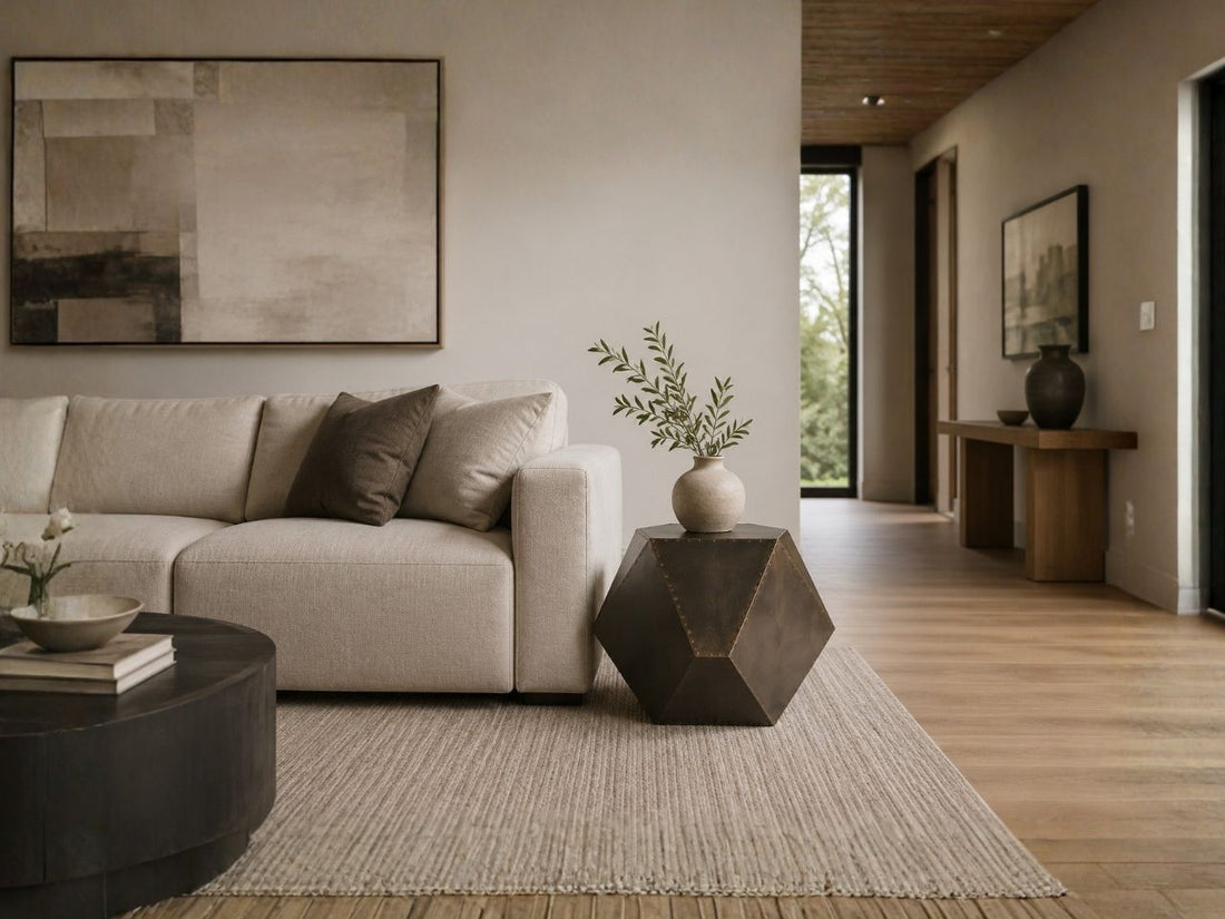 Geometric metal side table beside a cream sofa in a modern living room.