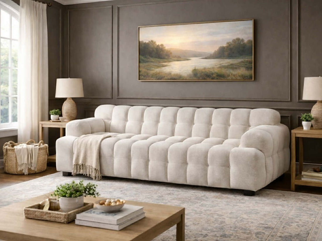 Tufted sofa upholstered in textured fabric, styled in an elegant living room with neutral décor.