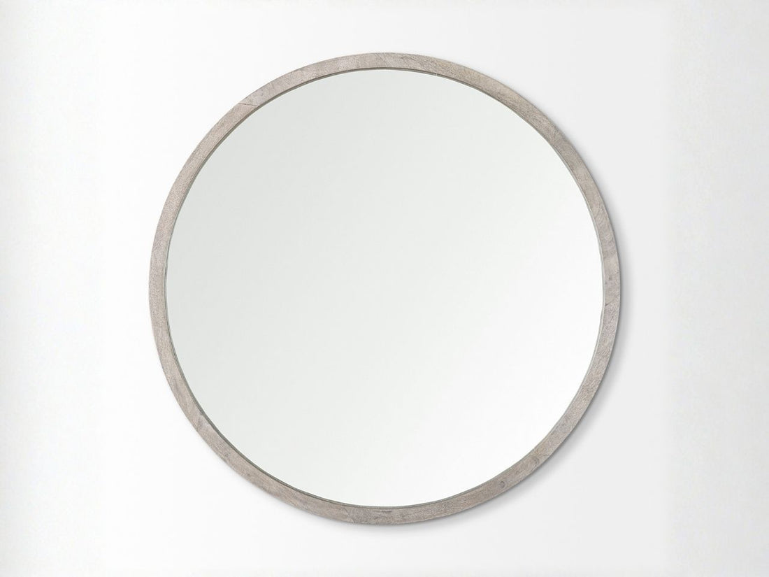 Round mirror with a silver frame in Calgary on a white background