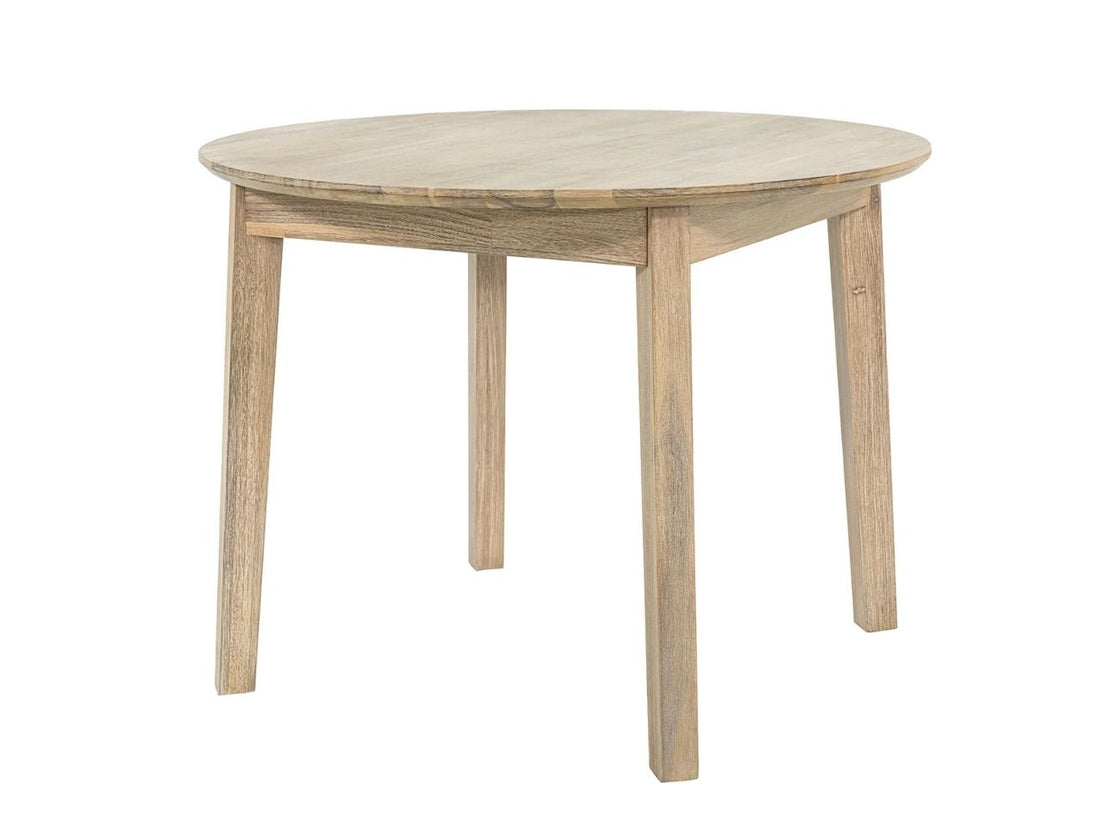 Round light wood dining table with chairs in a bright, cozy dining room.