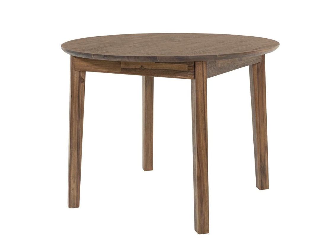 Round wooden dining table with chairs in a warm, modern dining room.