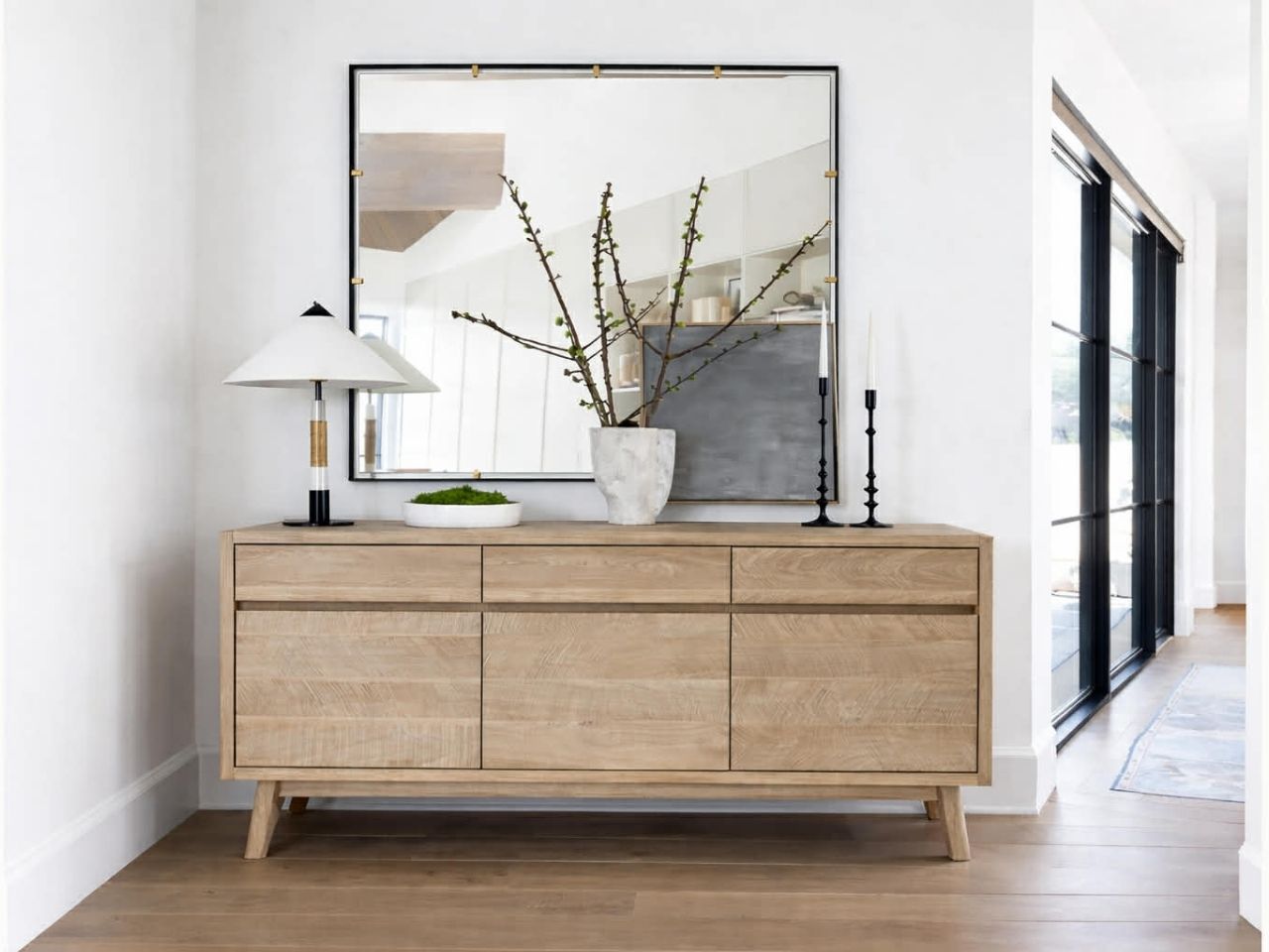 The Gia Sideboard is a contemporary storage piece made from light-finished wood with a visible grain.