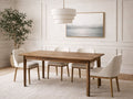 Small wood extension dining table with upholstered chairs in a bright dining room.