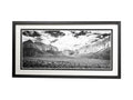 Framed black and white landscape print of a canyon with mountains and clouds.