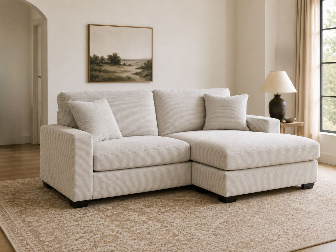 Light sectional sofa with chaise in a cozy, modern living room.