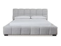 Light gray upholstered bed with tufted headboard and white bedding, front view.