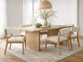 Light wood dining table with woven base panels and upholstered chairs in a bright dining room.