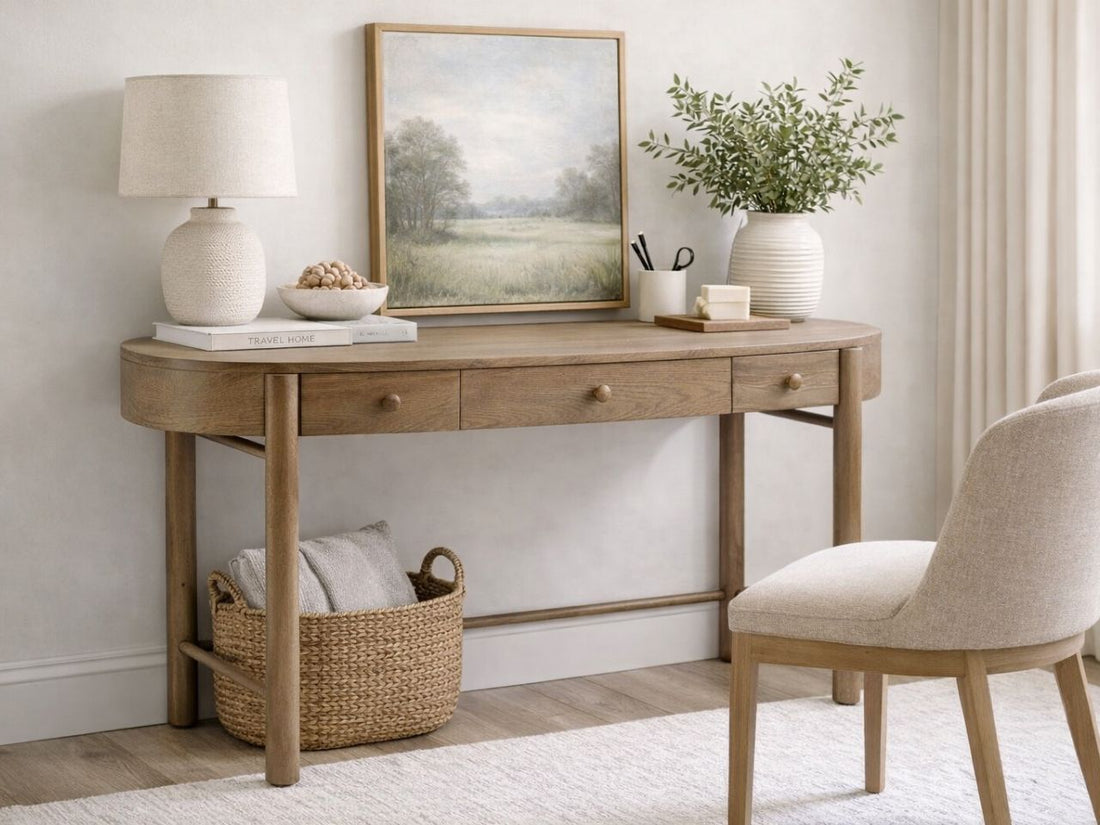 The Hadleigh Desk features a soft, transitional design with a distinct oval-shaped tabletop.