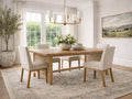A light wood dining table with upholstered chairs in a bright, neutral dining room.