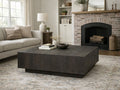 Dark brown square wooden coffee table in a modern living room.