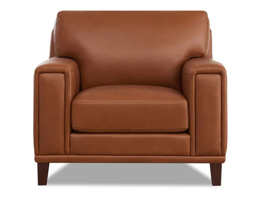 Cream leather accent chair with a clean modern silhouette, padded arms, a loose seat cushion, and tapered wooden legs, shown from the front on a white background.