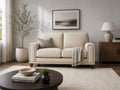 Cream leather loveseat with accent pillow in a bright, modern living room.