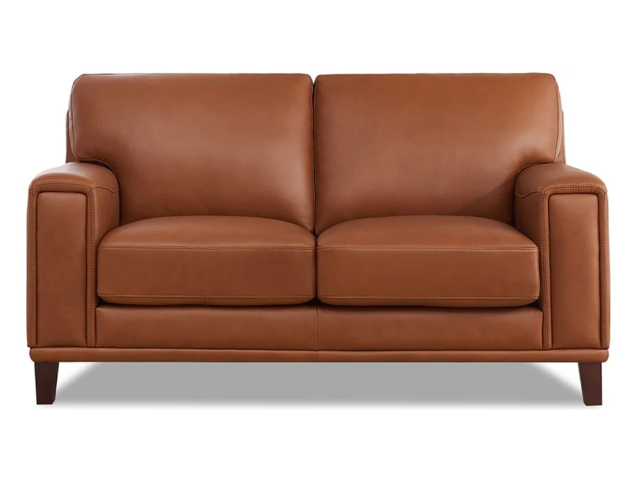 A contemporary leather loveseat featuring a structured silhouette, wide arms, and supportive seating, shown in warm medium brown leather on a white background.