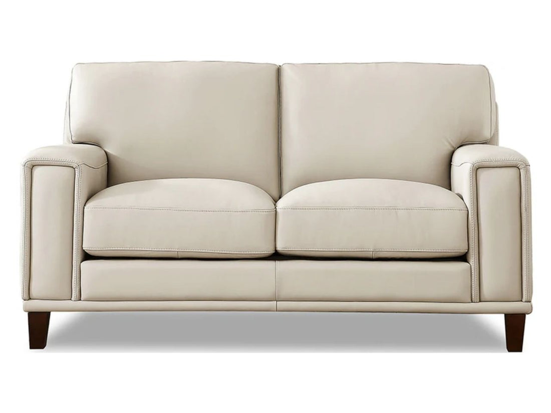 A modern two-seat leather loveseat with clean lines, wide arms, and plush cushions, upholstered in soft off-white leather and shown against a white background.