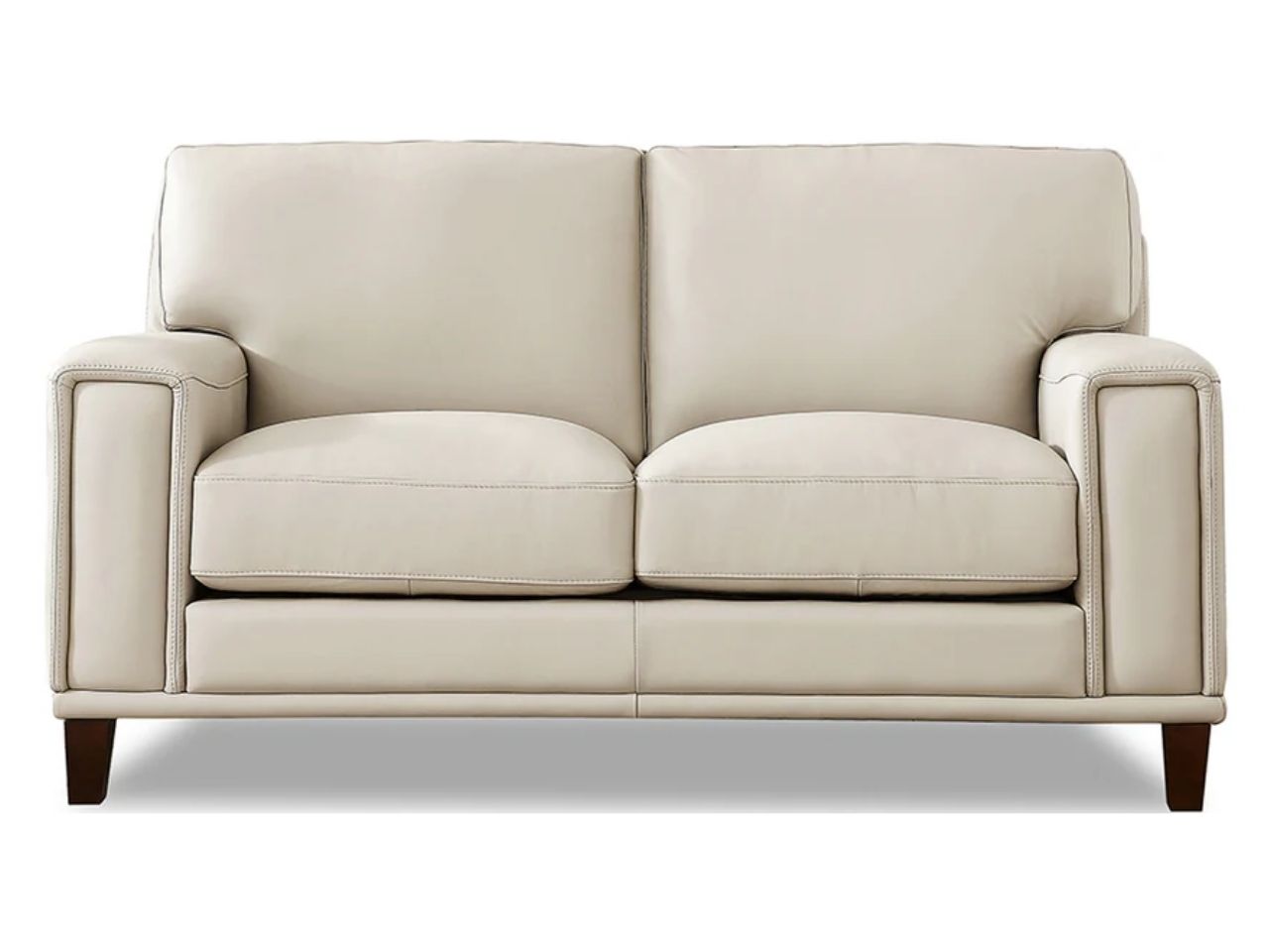 A modern two-seat leather loveseat with clean lines, wide arms, and plush cushions, upholstered in soft off-white leather and shown against a white background.
