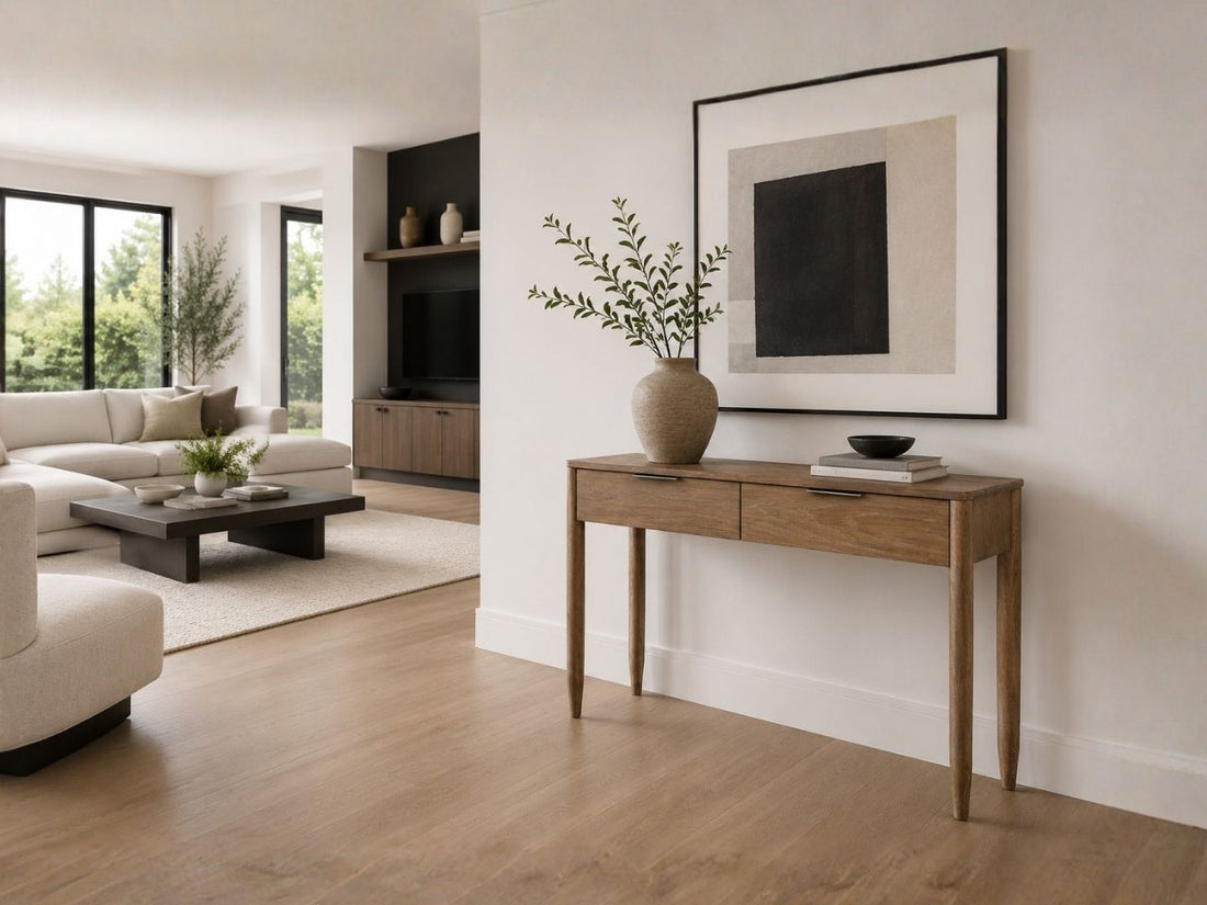 Light wood console table styled in a modern living room with neutral decor.