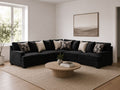Charcoal sectional sofa with accent pillows in a modern living room.