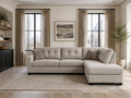Light beige sectional sofa with chaise in a bright modern living room with city views.