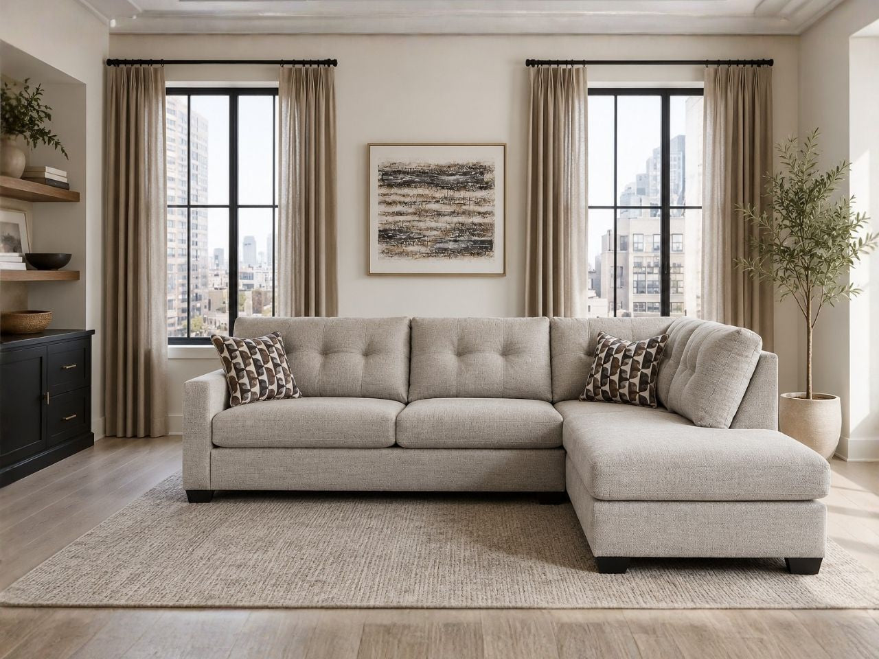 Light beige sectional sofa with chaise in a bright modern living room with city views.