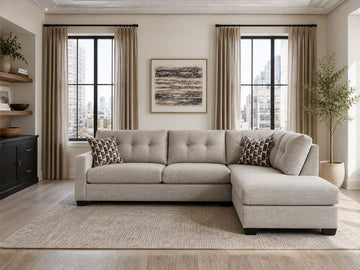 Light beige sectional sofa with chaise in a bright modern living room with city views.
