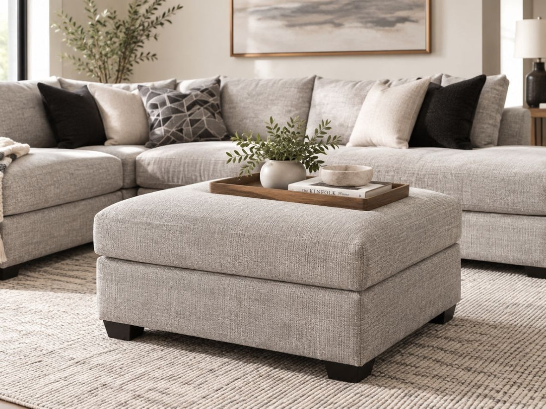 Light grey upholstered ottoman styled in a modern neutral living room, a versatile ottoman in Calgary for comfortable contemporary homes.