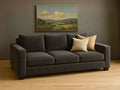 Memories Custom Sofa with beige pillows in a room with a landscape painting on the wall.