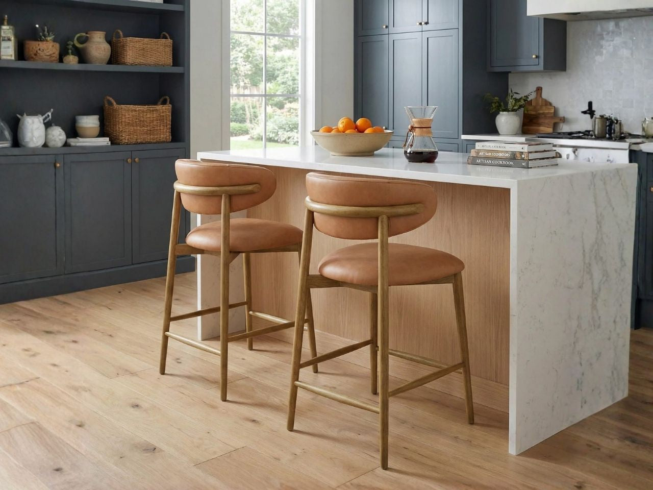 Tan leather counter stools at a marble kitchen island.
