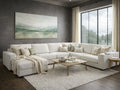 Light-colored sectional sofa styled in a modern living room with a wood coffee table, neutral decor, and large window.