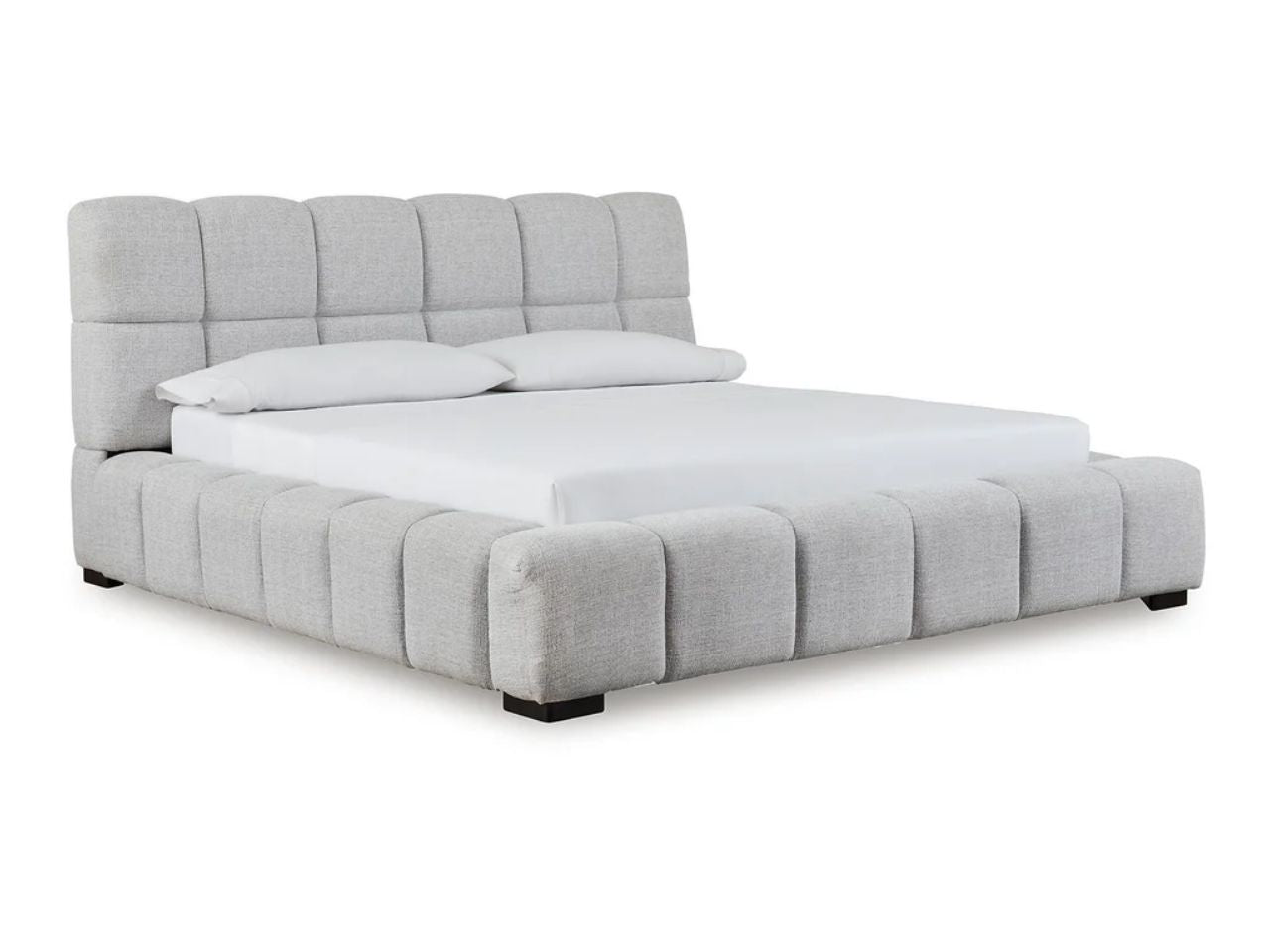 A modern upholstered bed with a plush, channel-tufted frame and padded headboard in a white background.