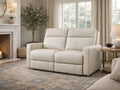 Light cream reclining loveseat with plush cushions, upholstered in soft fabric or leather, styled in a bright, neutral living room.