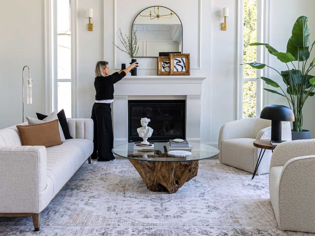 Round glass coffee table with a natural wood root base in a modern living room.